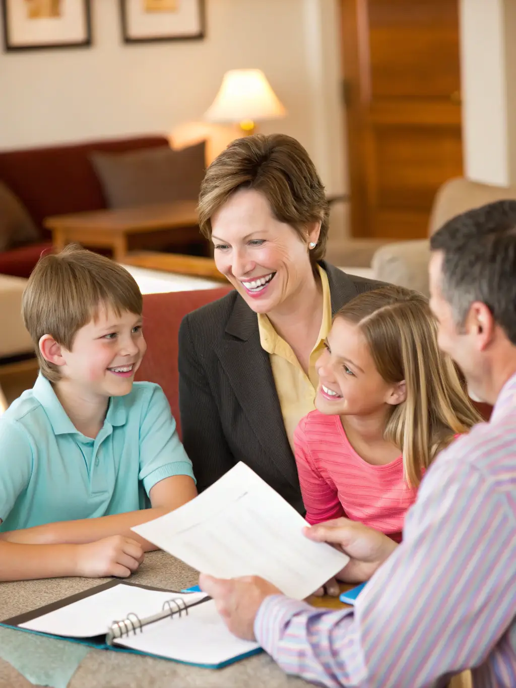 A young family meeting with a financial advisor to discuss long-term financial planning and savings goals for their children's future.